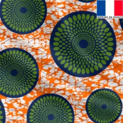 Lycra orange imprimé wax rosace bleue à pois verts
