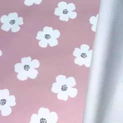 Tissu imperméable type ciré vieux rose motif fleur blanche