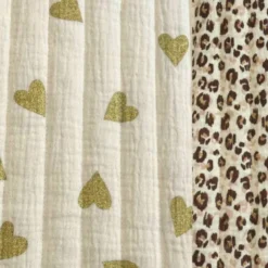 Tissu matelassé réversible motif léopard et coeurs dorés